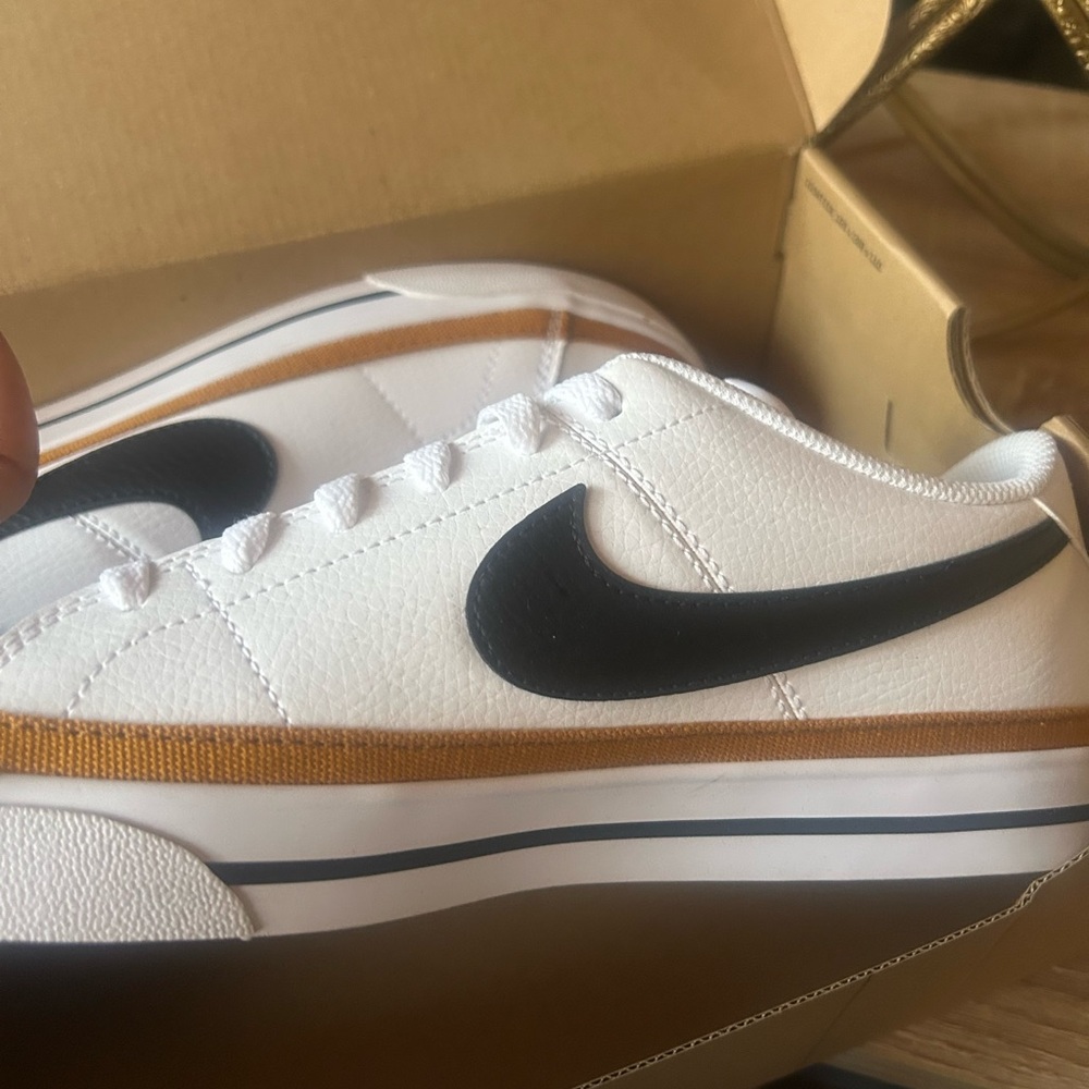 Nike Womens White and Black Sneakers with Gold Stripe